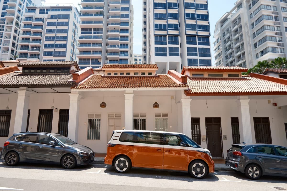Orange bus, white shophouses